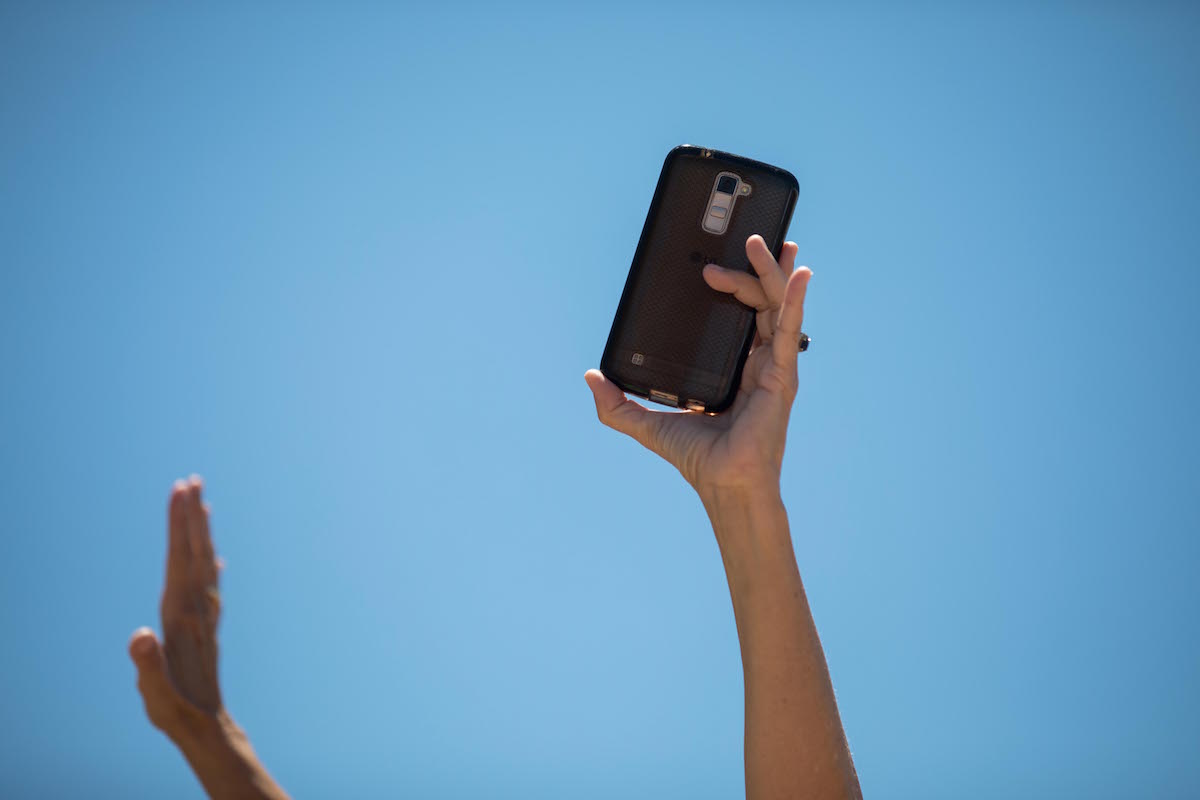 a cell phone being held in the air