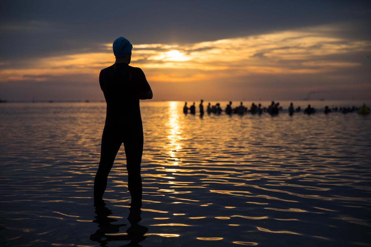 silhouette of a person standing in the water