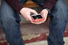 A man checks out an app on his iPhone.