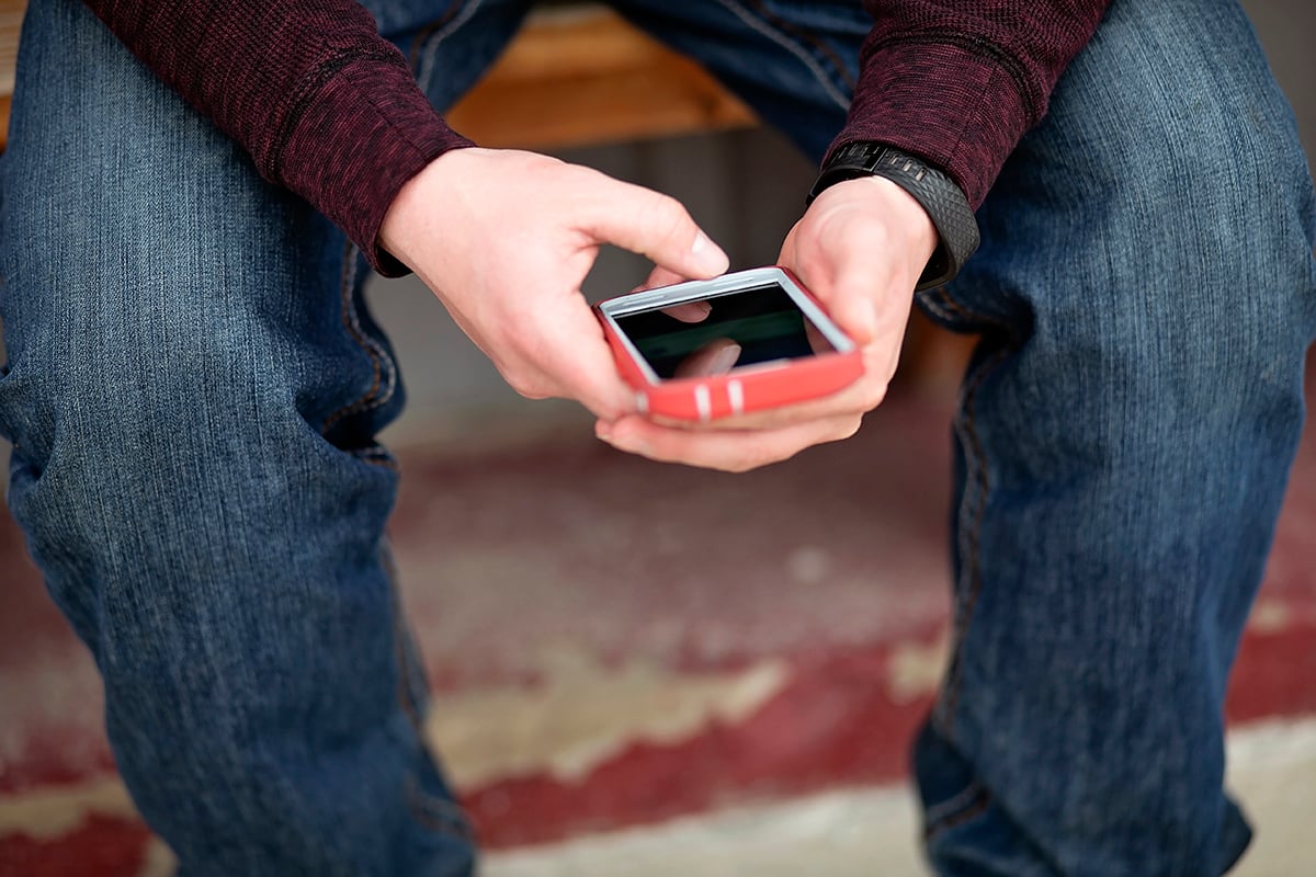 A man checks out an app on his iPhone.