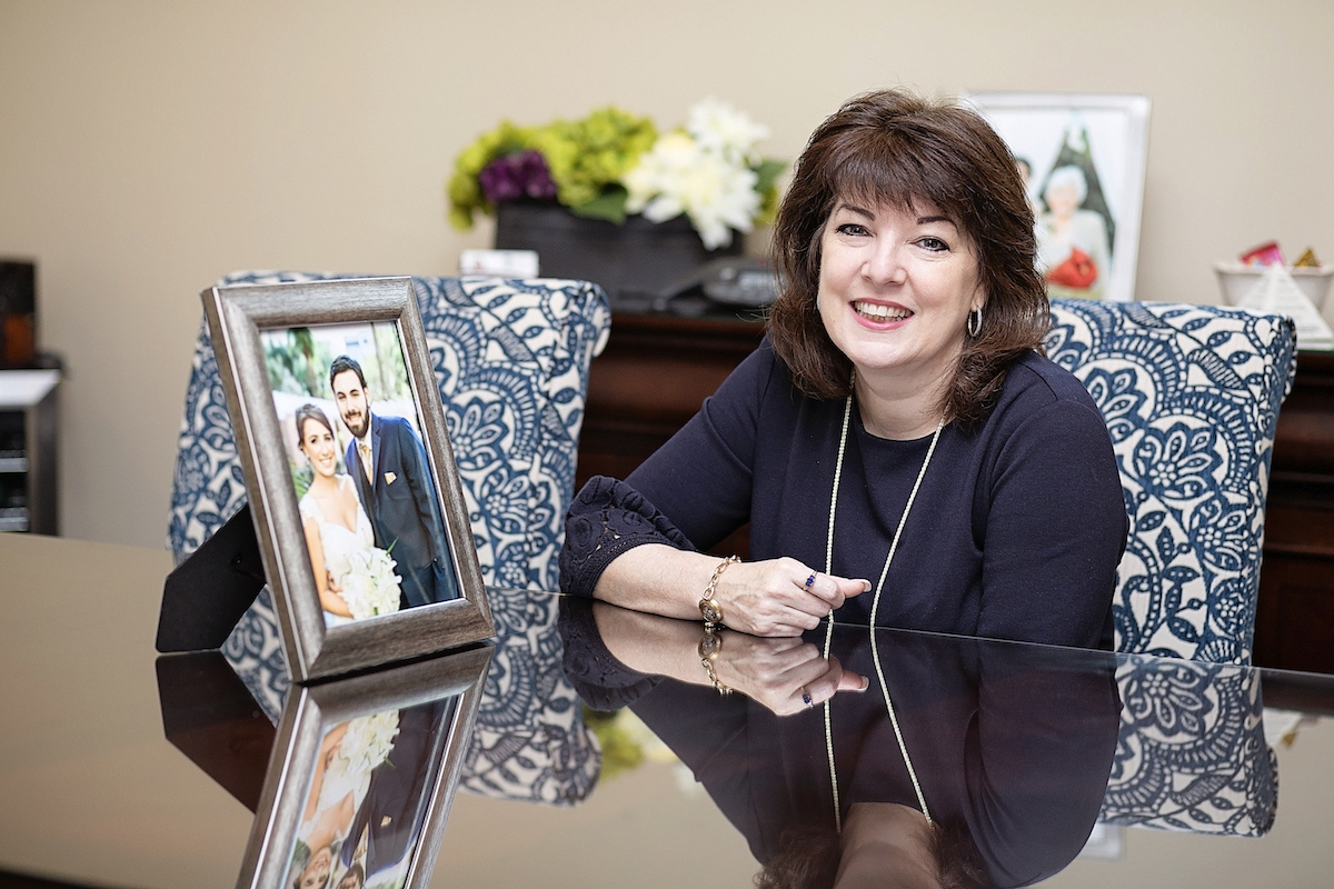 Pastore poses with a photo of her children, Nicole and Anthony, in her Palm Harbor office.