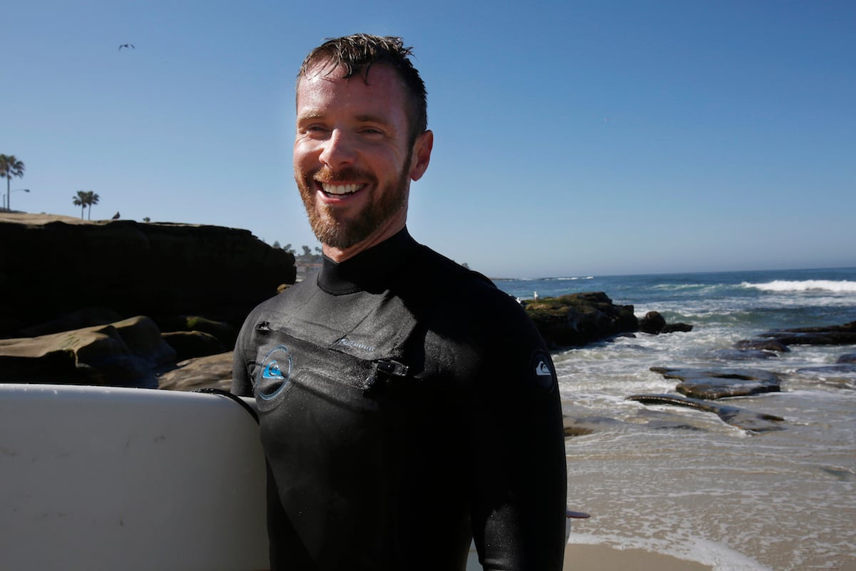 Matt Hoffman poses for a portrait with his surf board.