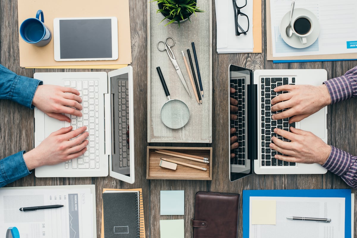 over view of two people working at laptops