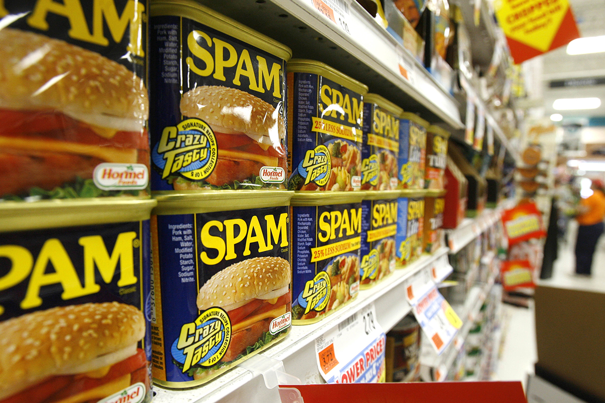 Cans of Spam on a store shelf