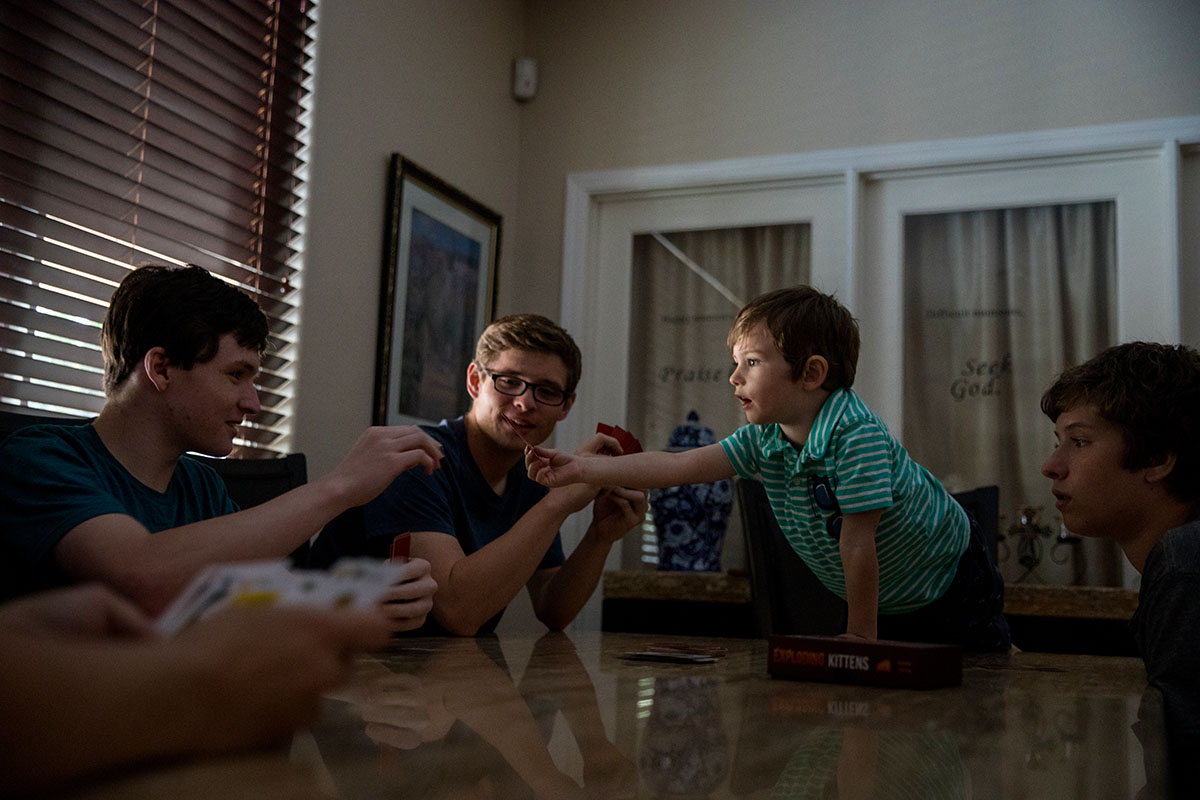 (Left to right) Brothers Jesse, Joshua, Noah and Thomas play cards in Visalia, Calif., Wednesday, May 23, 2018.