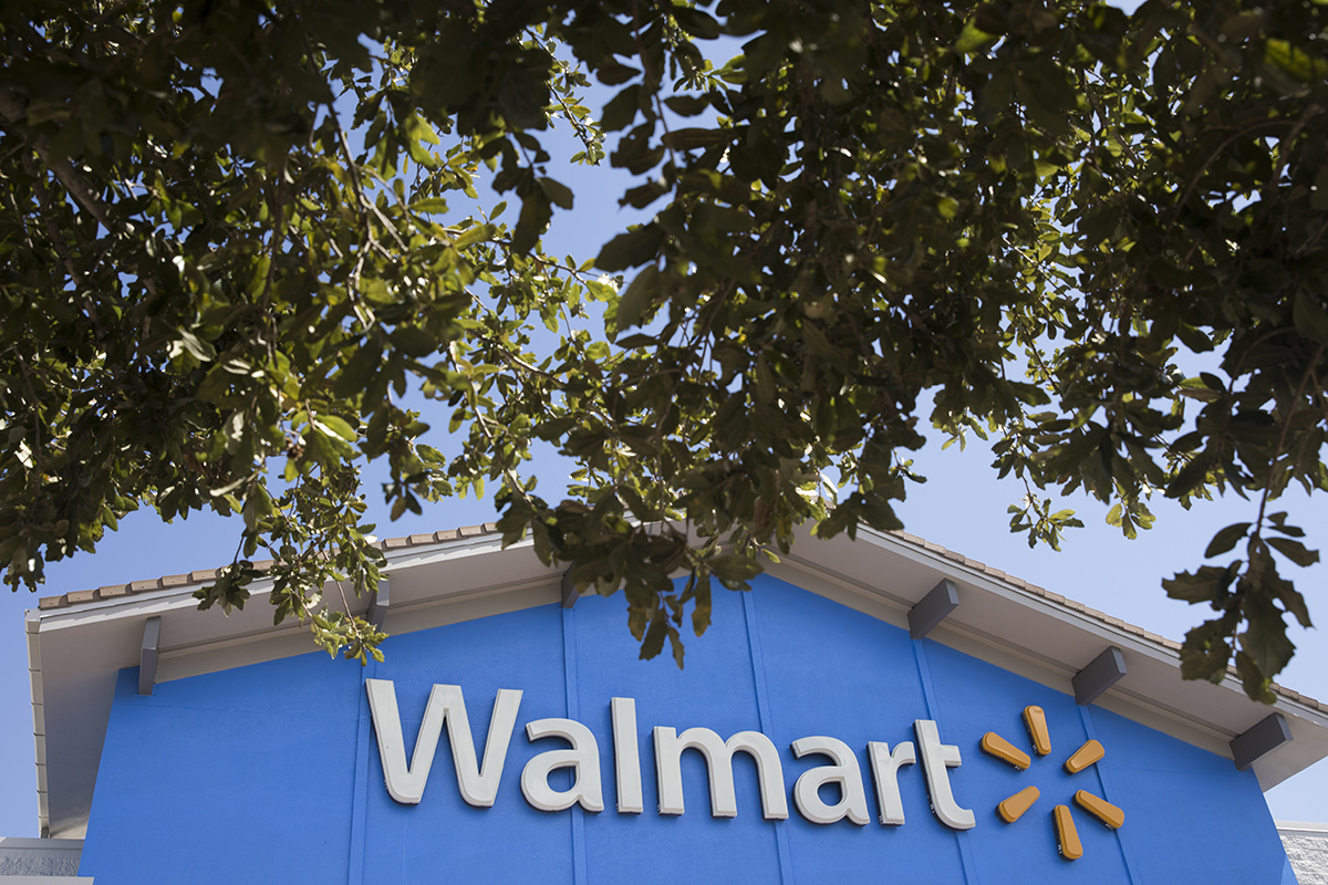 A Walmart sign is framed with trees in St. Petersburg, Florida.