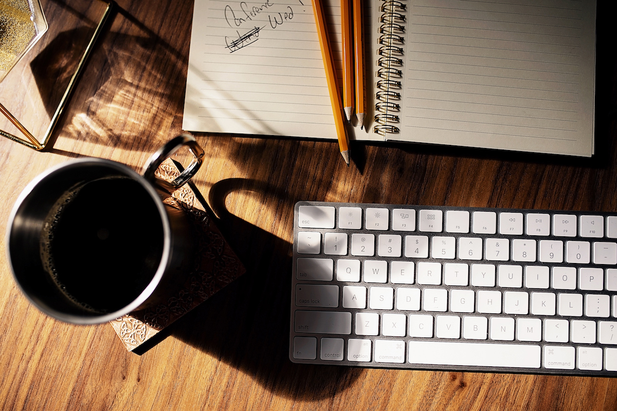 Detail of a laptop and keyboard on a desk