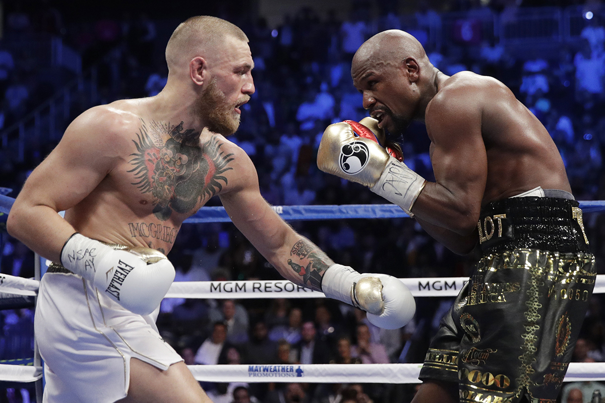 Floyd Mayweather Jr., right, fights Conor McGregor in a super welterweight boxing match Saturday, Aug. 26, 2017, in Las Vegas.