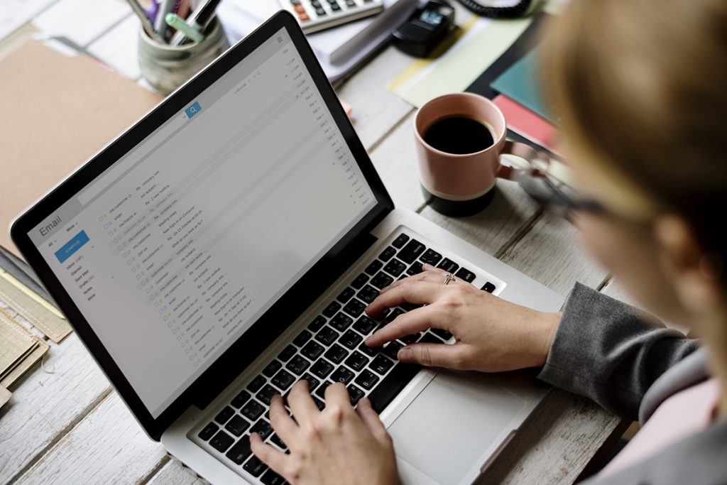 woman checking emails on laptop