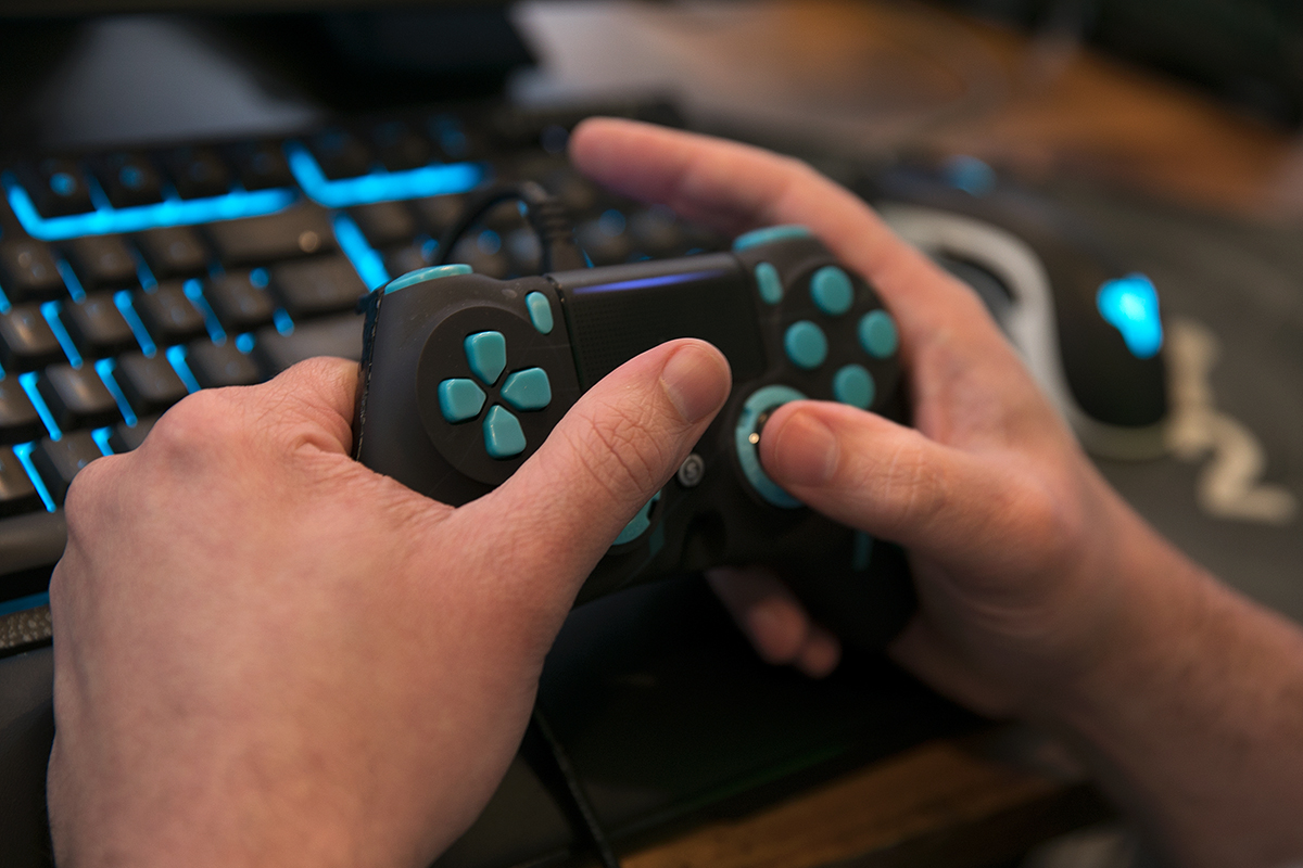 Photo of a Twitch gamer's hands and gaming console.