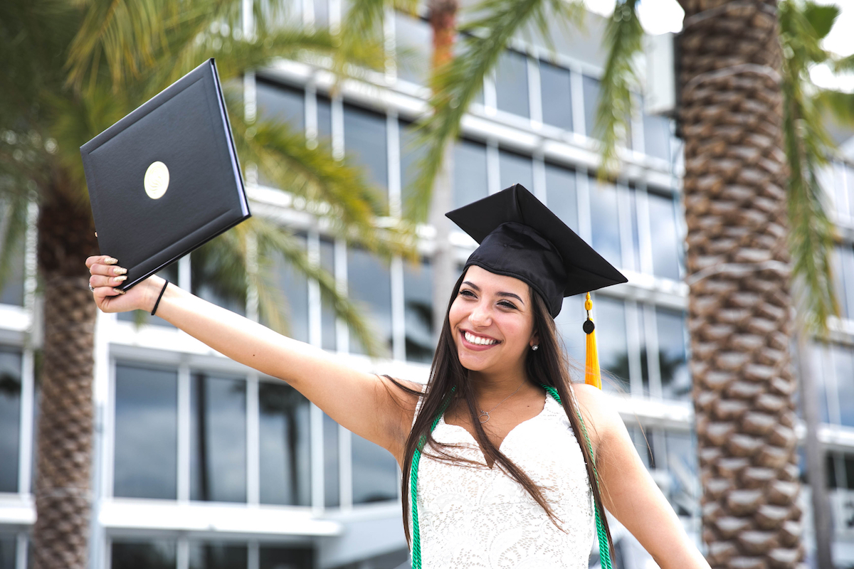 Ciara Bello, a psychology major, holds up her diploma after graduating from the University of Central Florida on May 4, 2018.