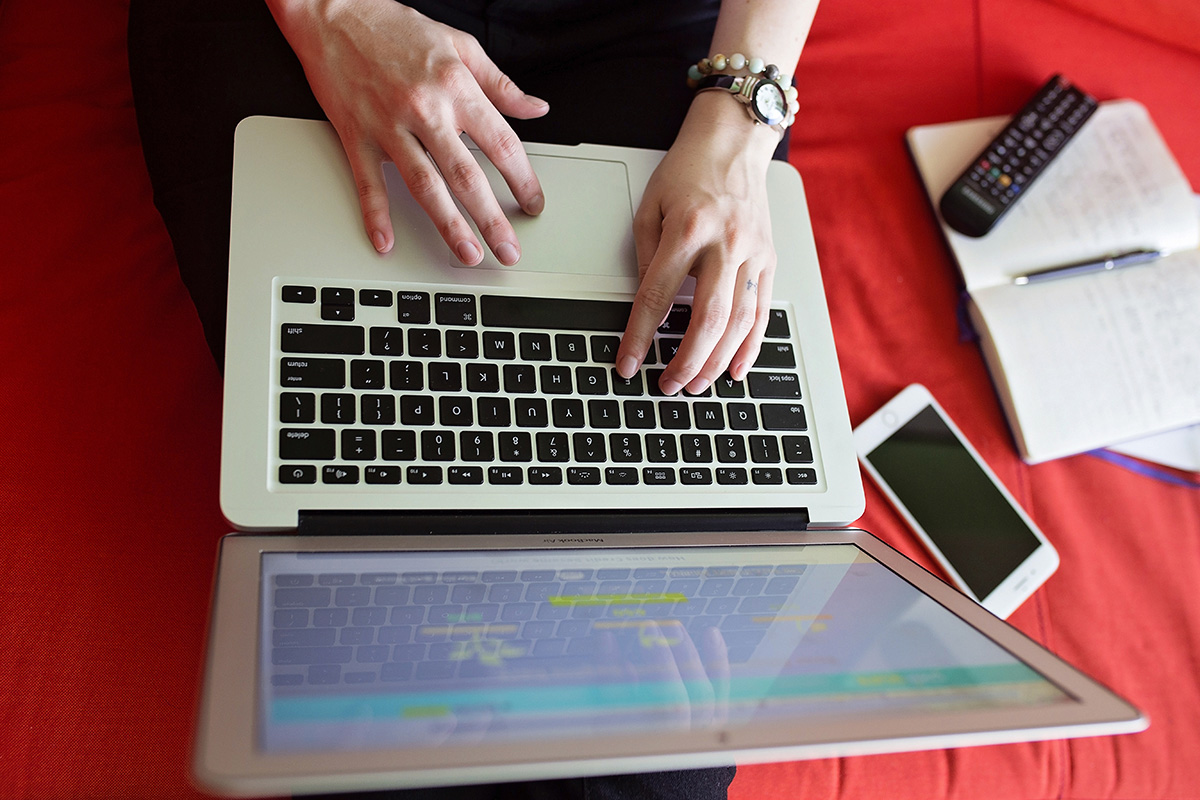 A woman works from home on her laptop computer