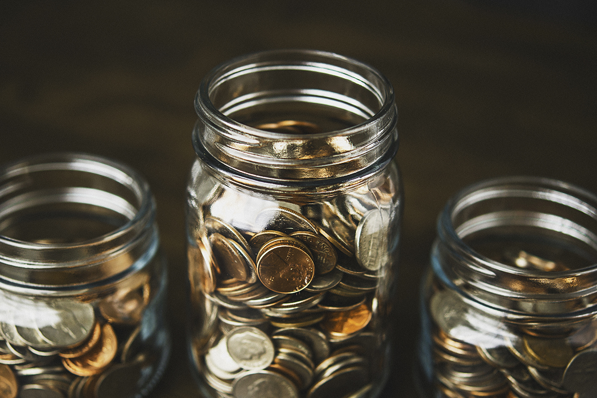 Money jars filled with American currency.