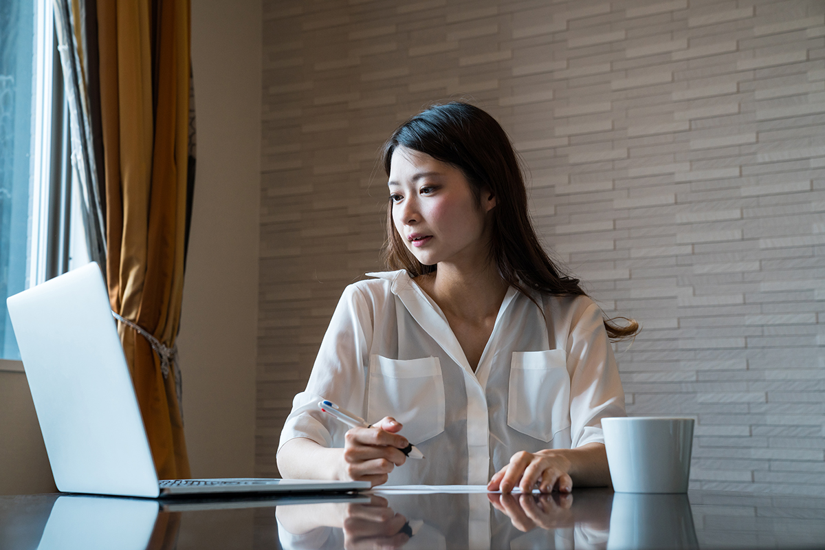 Woman filling out important paper documents