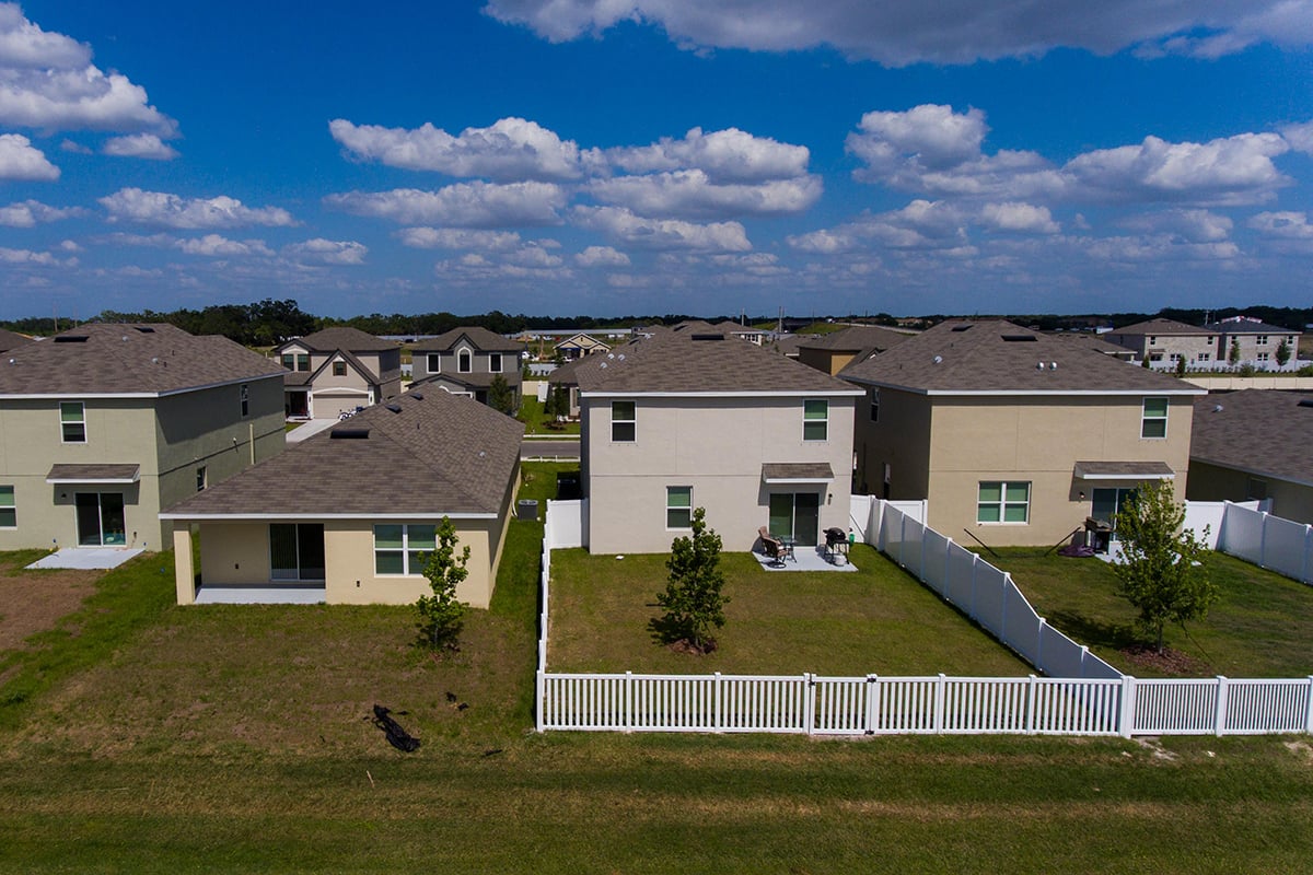 backyards and houses and a pretty blue sky.