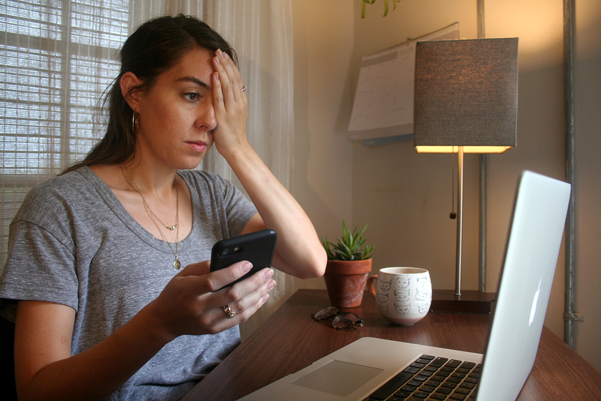 a woman takes an eye exam using a laptop
