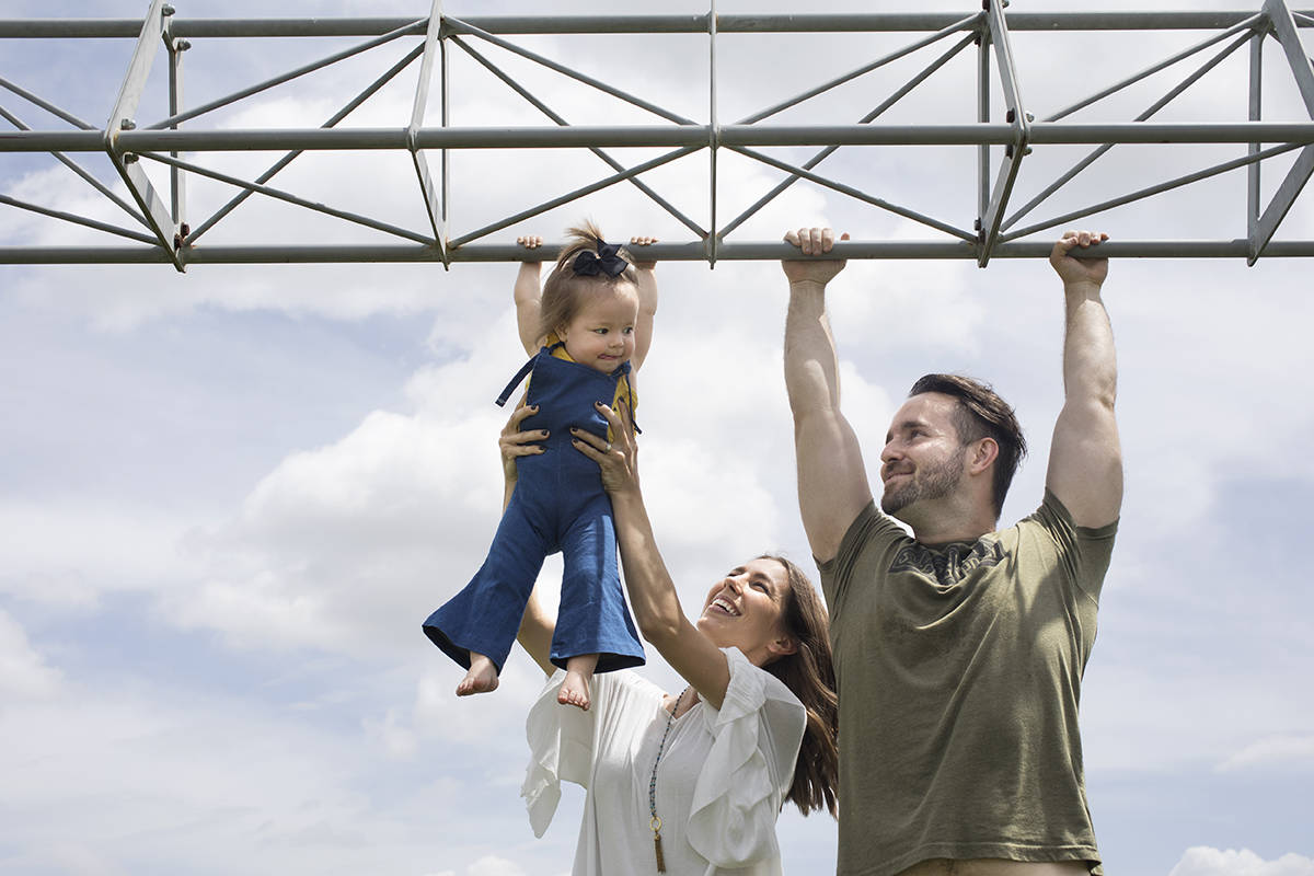 A family hang off the monkey bars at a park near their home in Florida.