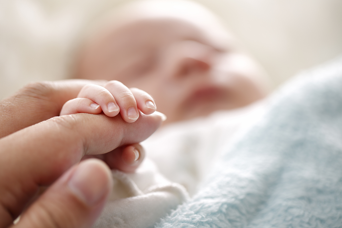 New born holding mom's fingers