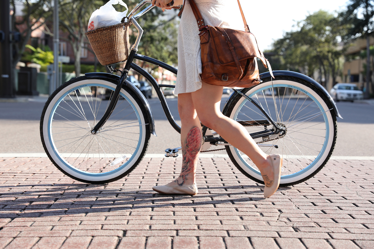 girl walking with her bike