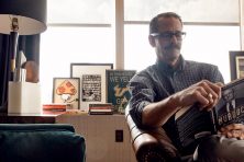 Sherman Zent sits reading a book in the Penny Hoarder office
