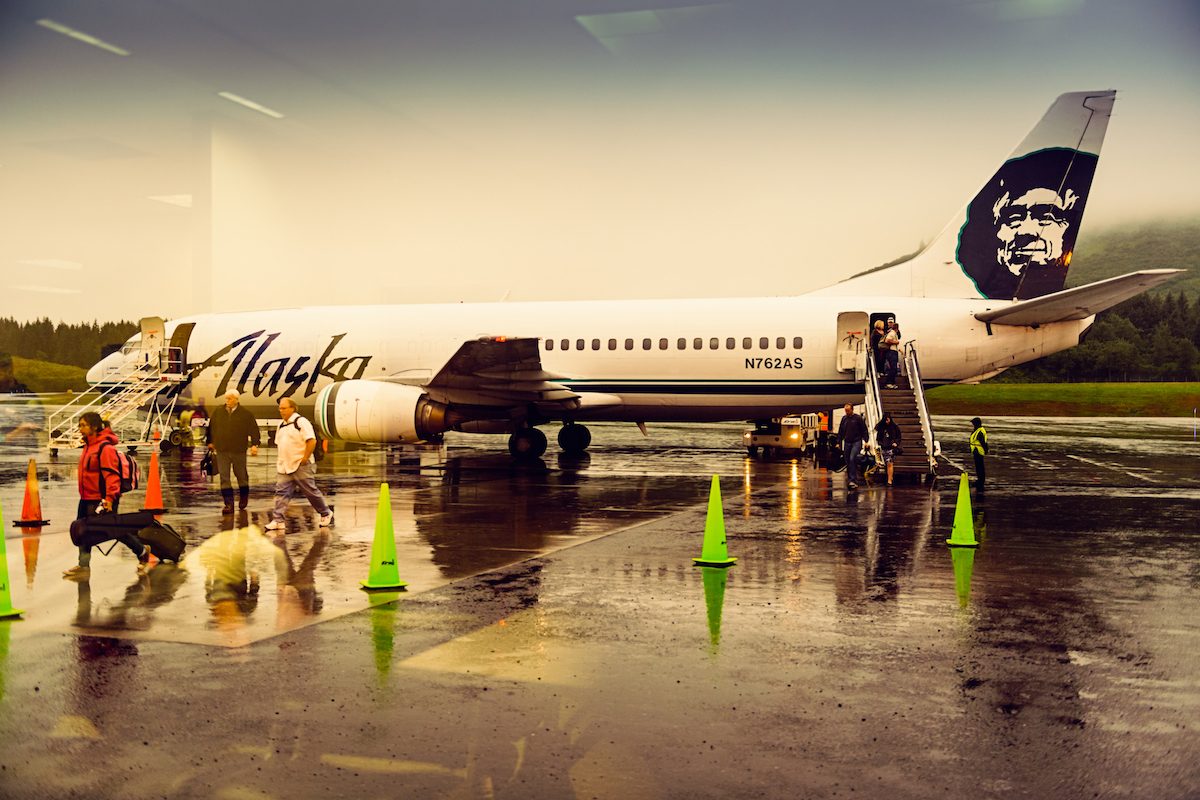 People Walk to the arrival area from an Alaska Airlines plane on August 16, 2013.