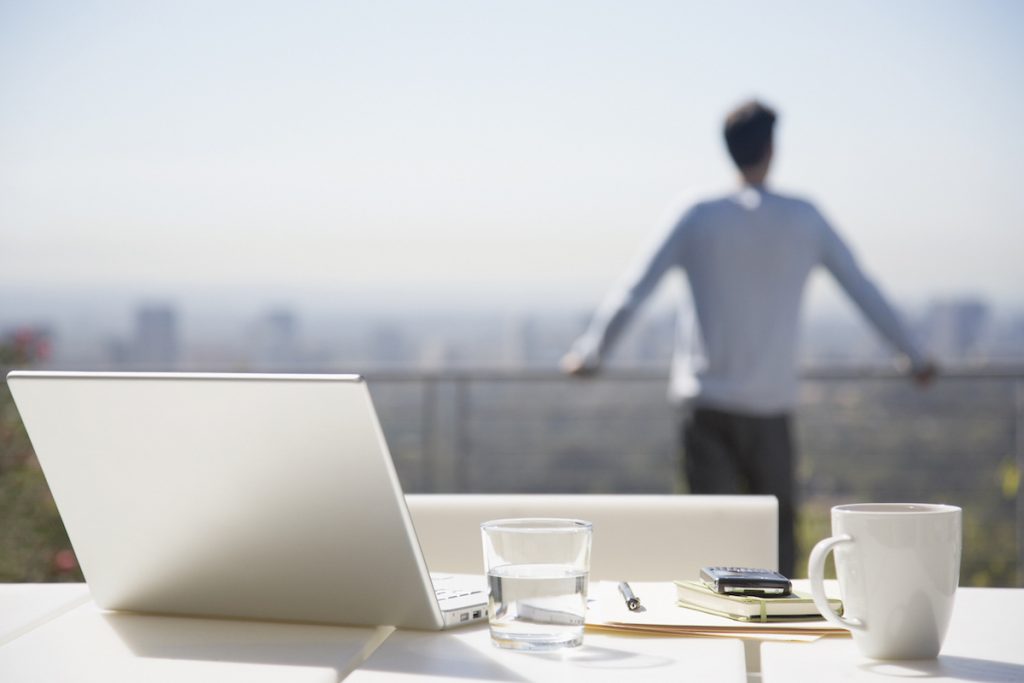 Man taking a break from working on balcony