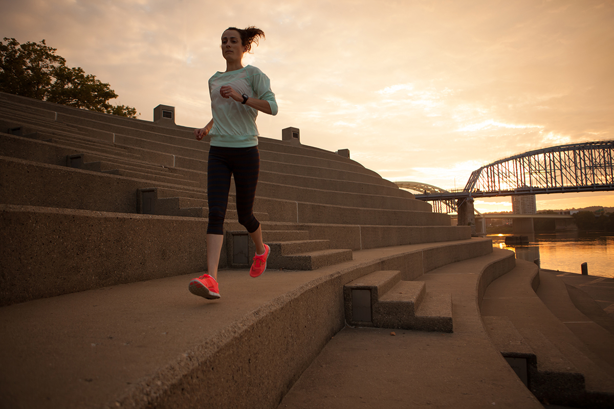 Woman running along Ohio River in downtown Cincinnati.