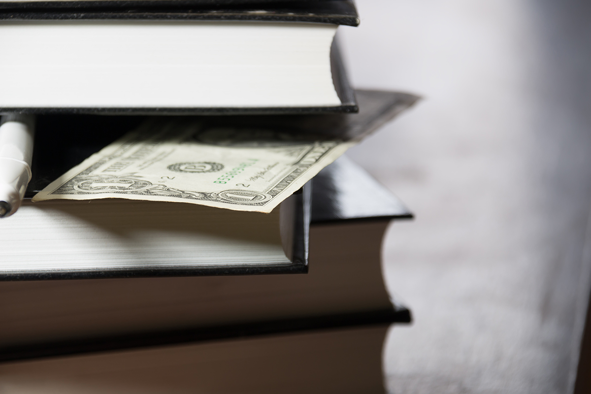 pile of books and money