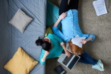 above view of exhausted couple trying to cope with taxes