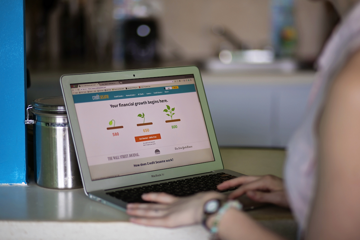 A woman using her laptop to check her credit score.