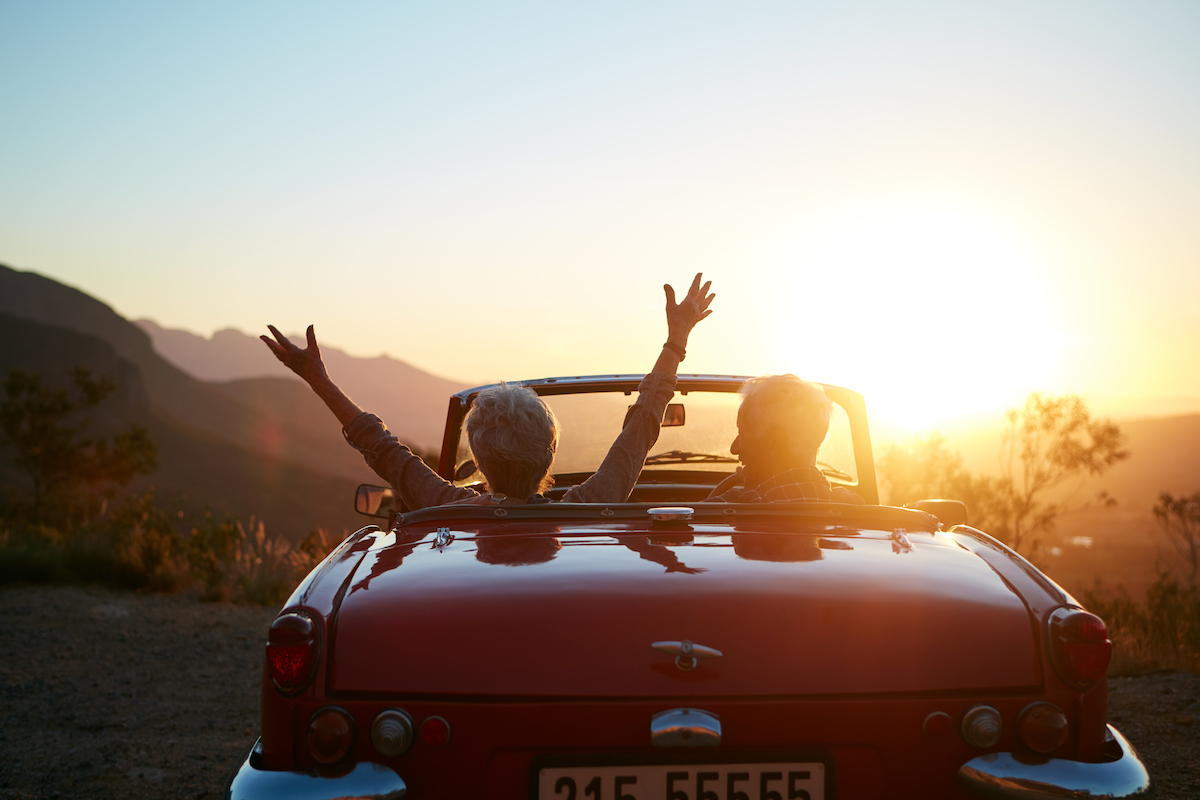 Shot of a joyful senior couple enjoying the sunset during a roadtrip
