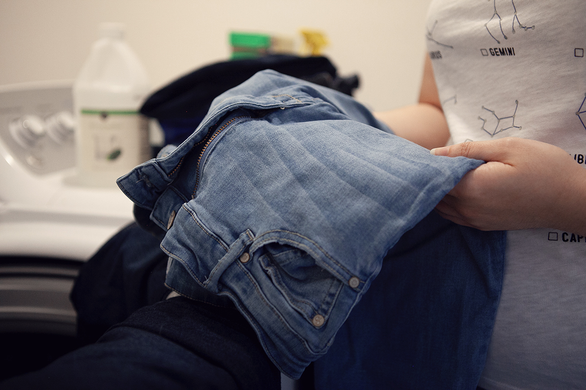 Michaela Estes pre-treats her denim jeans before putting them in the wash.