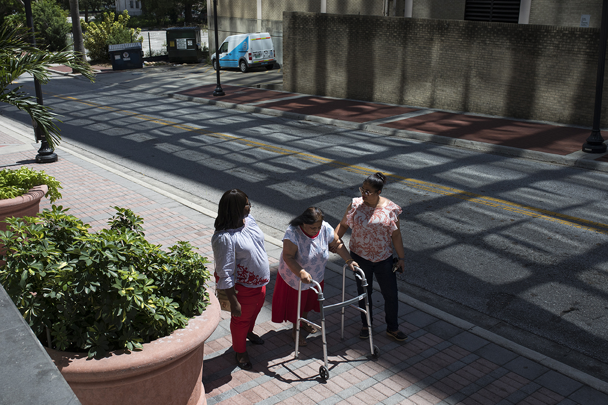 Three people walk back to their apartment in downtown Orlando.