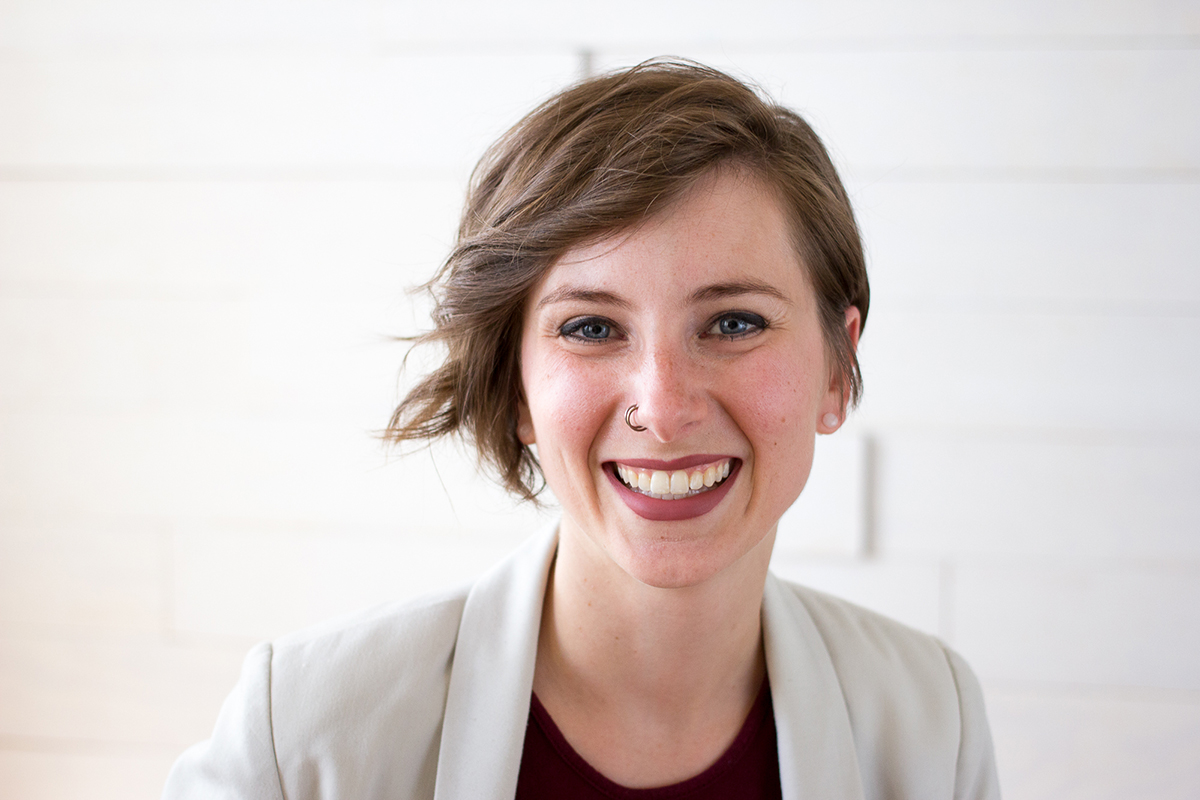 A young business woman smiles.