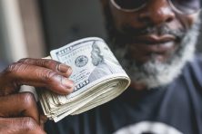 Albert Bell holds cash in downtown Atlanta. Atlanta GA, on July 28th, 2018.