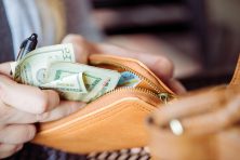 A close look at a woman handling her bills. Saturday Aug. 24, 2018, in Cleveland, Ohio.