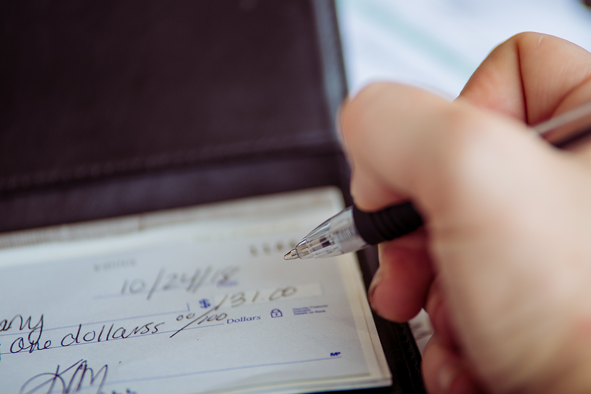 A close look at a woman handling her bills.