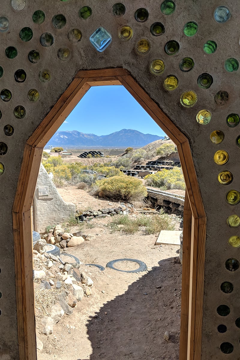 A view of the desert through the doorway of an eartthship.