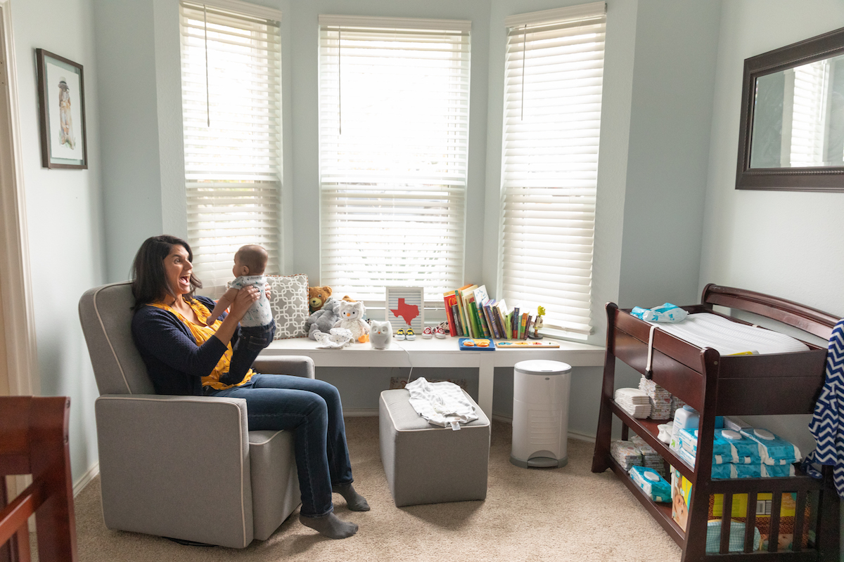 Laura Neibauer plays with her infant son in his nursery in Austin, TX.