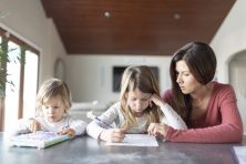 Vanessa Worthen helps her daughter Avey Levin, 6, with her homework as her son J.J. Levin, 2, looks on Tuesday, Dec. 18, 2018 in their Novato, California home.