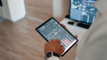 Person reviewing their investment portfolio and retirement savings using Empower app