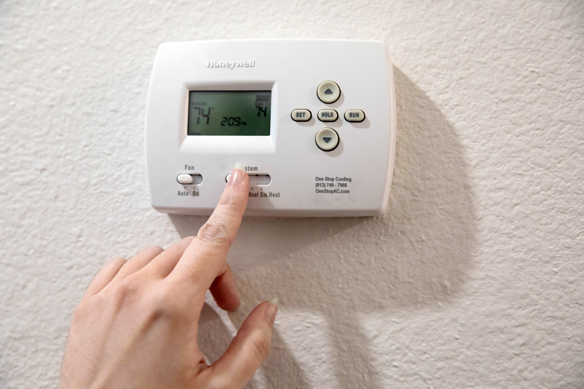 A person turns down the heat in their home.