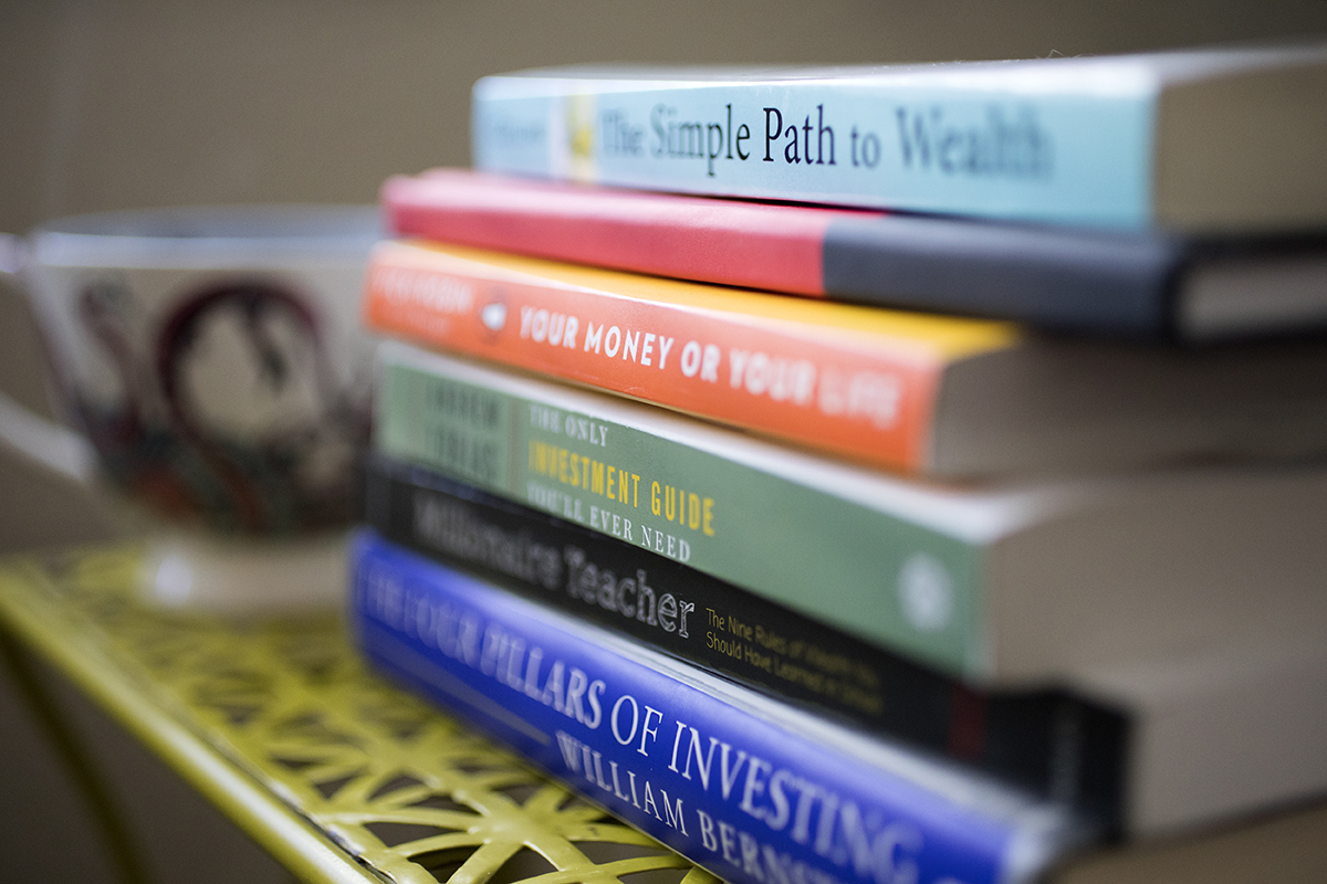 A stack of books sits on a table.