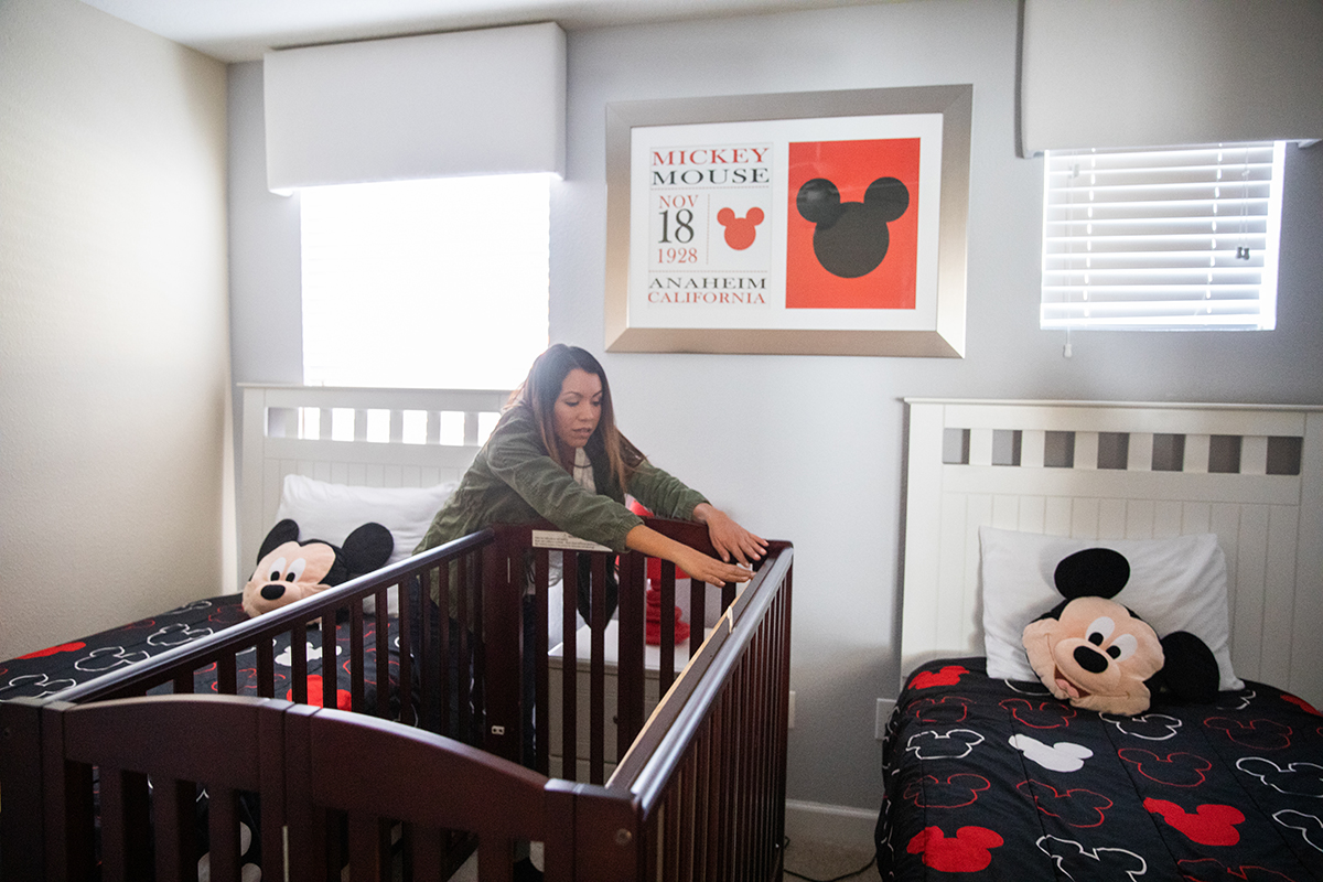A woman sets up a crib