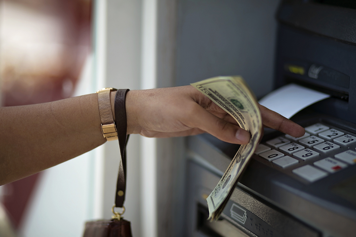 Woman using atm