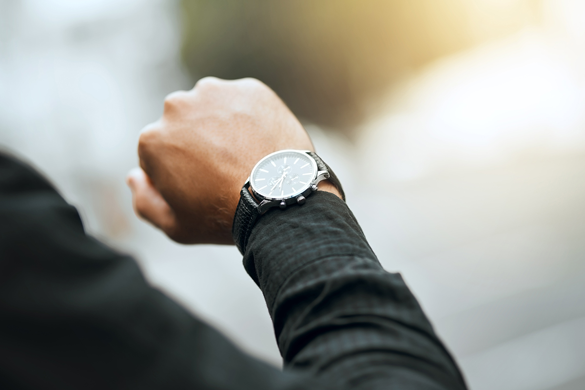 Cropped shot of an unrecognizable man checking the time while traveling through the city