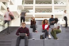 Students study and socialize in a building on a university campus.