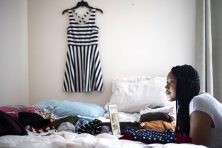 A woman posts clothes she is selling online.