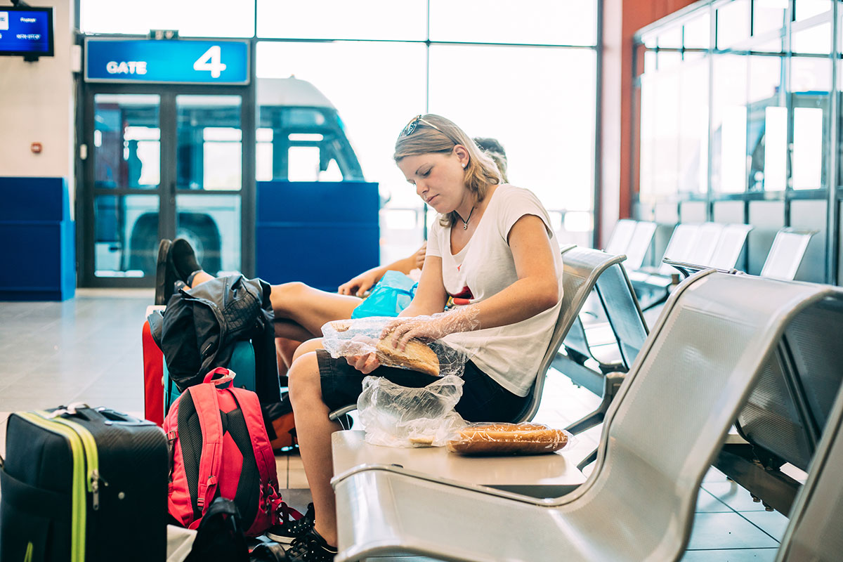 women eating packed sandwiches while traveling