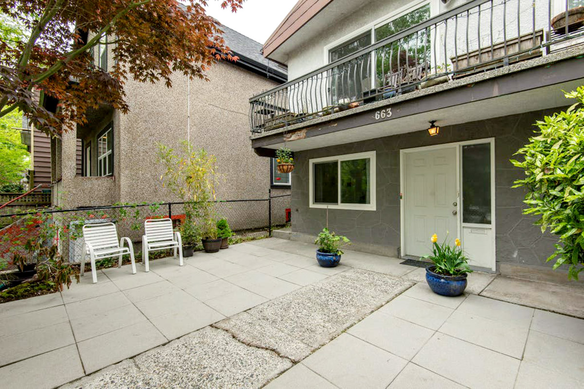 The front of an apartment and it's small courtyard.
